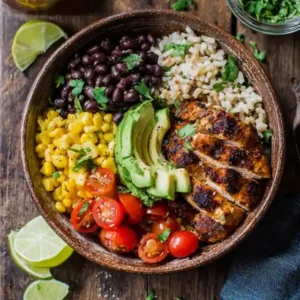 High protein burrito bowl with grilled chicken, beans, rice, avocado, and vegetables