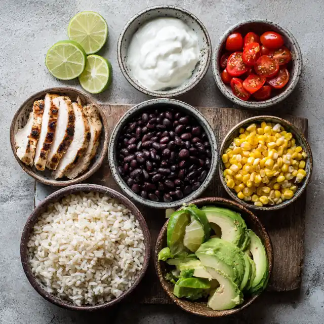 Separated ingredients for high protein burrito bowl laid out on a table
