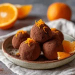 Chocolate orange truffles coated in cocoa powder on plate