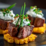 Tenderloin cubes on crispy potato rounds with horseradish cream and herbs